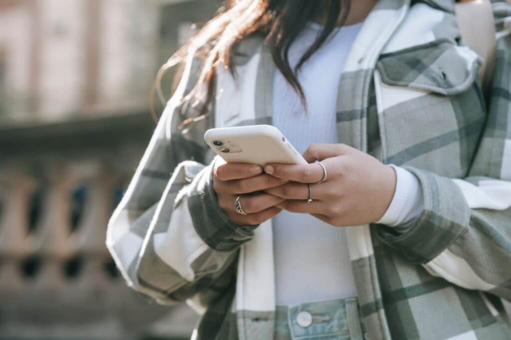 unrecognizable-female-in-street-with-cellphone-5965635-1024x682